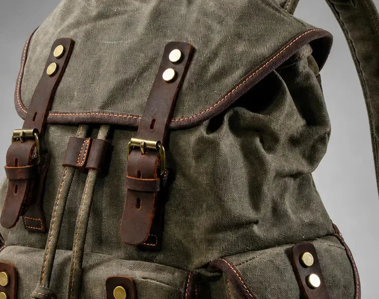 Close-up of canvas, leather straps and stitched seams on the Leon hiking backpack